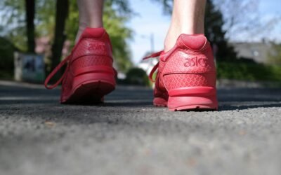 a person's feet in red shoes