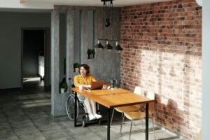 a woman sitting at a table with a laptop