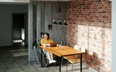 a woman sitting at a table with a laptop