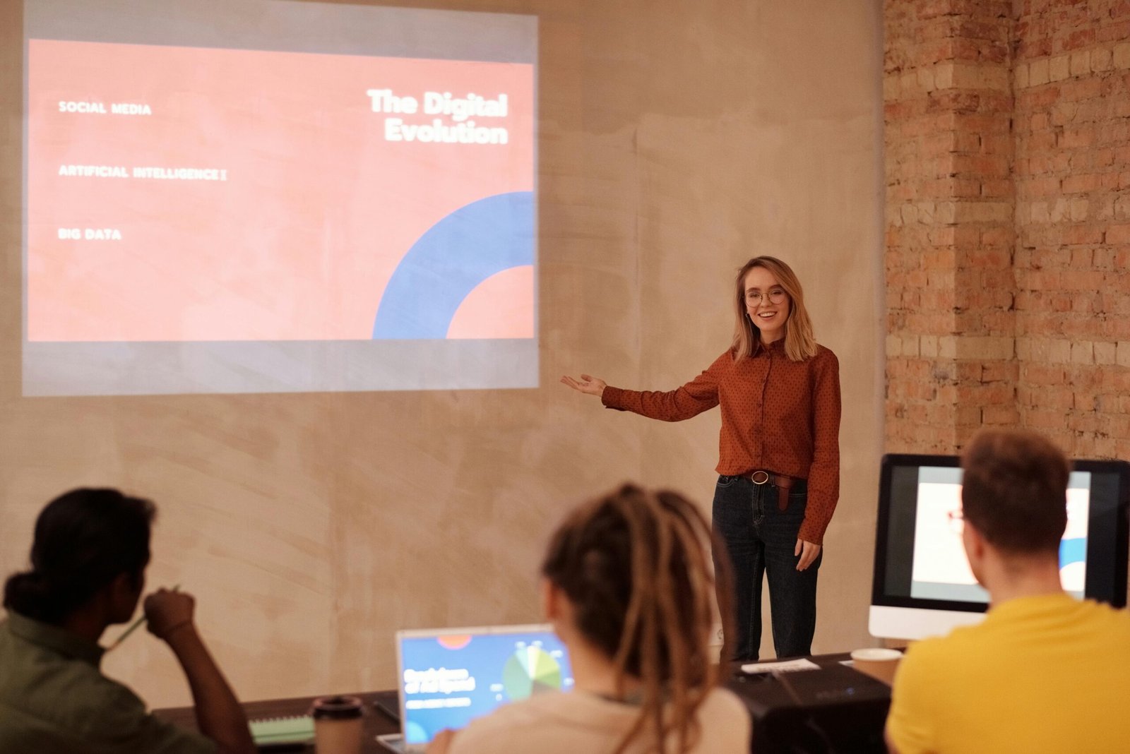 a woman standing in front of a projector screen