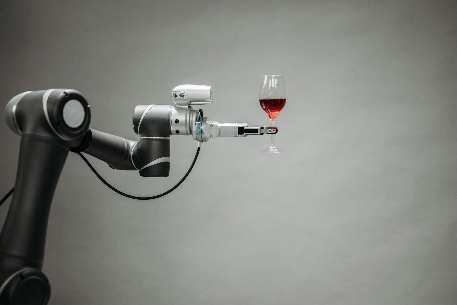 a robotic arm holding a glass of wine