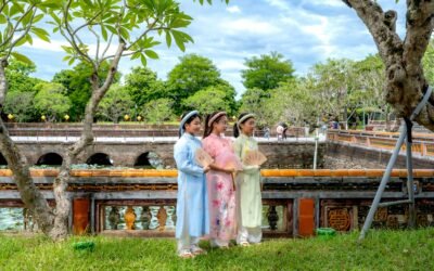 a group of girls wearing traditional dresses standing on grass