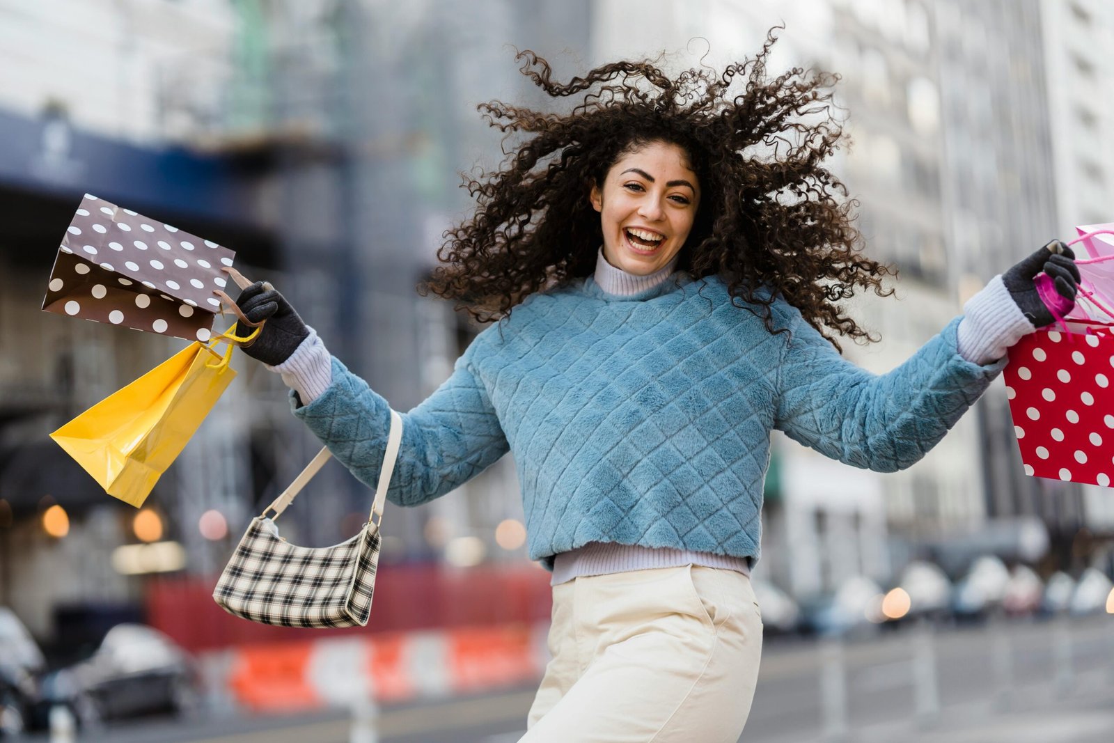 a woman holding shopping bags and smiling